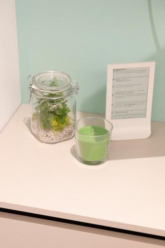 a mason jar and a bowl of green liquid on a counter at Marigold Residence in Roseto degli Abruzzi