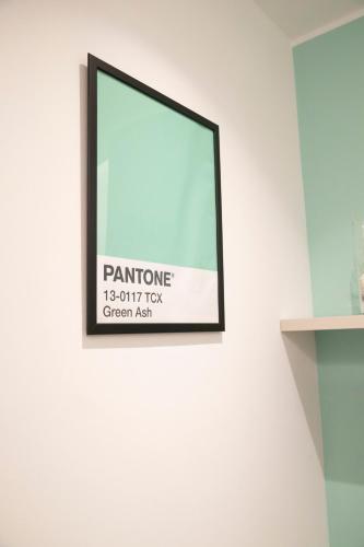 a framed picture hanging on a white wall at Marigold Residence in Roseto degli Abruzzi
