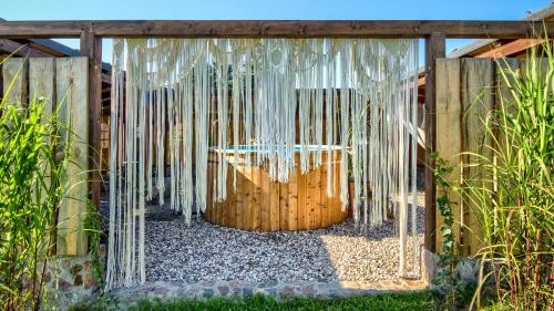 a gate in a fence with icicles at Pod Mazurskim Niebem boho in Piecki