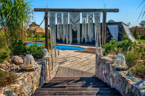 an entrance to a resort with a swimming pool at Pod Mazurskim Niebem boho in Piecki