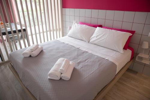 a bed with two pairs of towels on it at Marigold Residence in Roseto degli Abruzzi