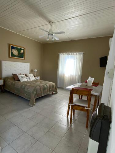 a bedroom with a bed and a table and a window at Lo de Nora, ColónER in Colón