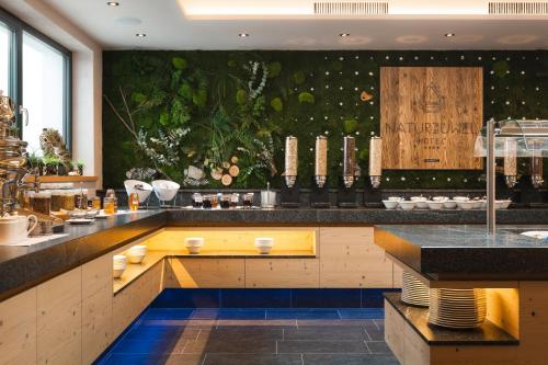 a kitchen with a bar with a counter top at Das Naturjuwel in Fiss