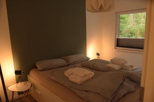 a bedroom with a bed with towels on it at Allerlichtung in Buchholz Aller