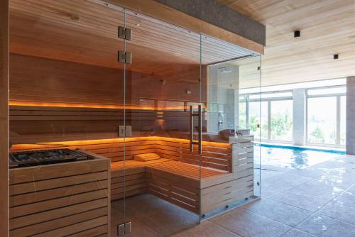 a sauna with a glass shower in a room at Hôtel Beau Site Talloires B SPA in Talloires
