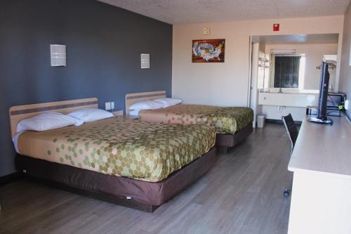 a hotel room with two beds in a room at Econo Lodge Paducah West I-24 in Paducah