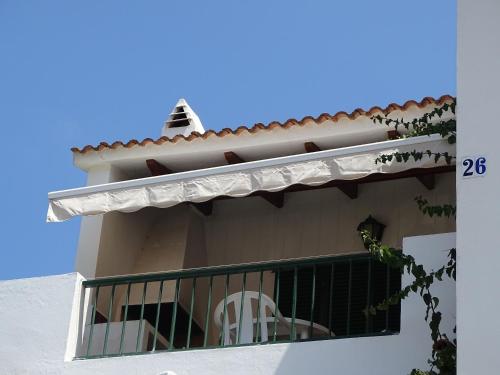 a balcony of a house with two white chairs on it at Apartamento Gecko in Son Parc