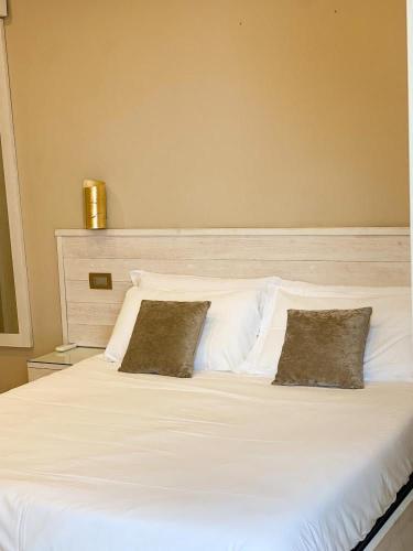 a large white bed with two pillows on it at La Ripa Camere Vernazza in Vernazza