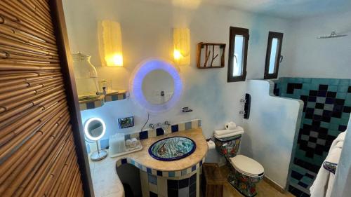 a bathroom with a sink and a mirror at Sueños Tulum in Tulum