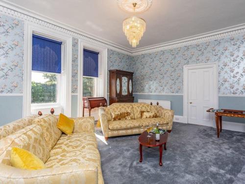 a living room with two couches and a table at North Bank House in Lybster