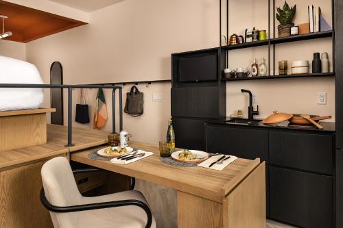 a kitchen with a table with two plates of food on it at Catbird Hotel in Denver