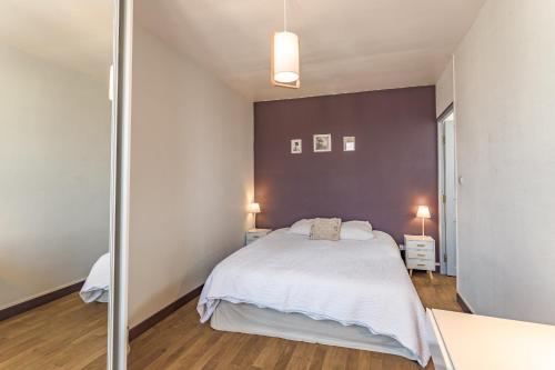 - une chambre avec un lit blanc et un mur en verre dans l'établissement Appartement 