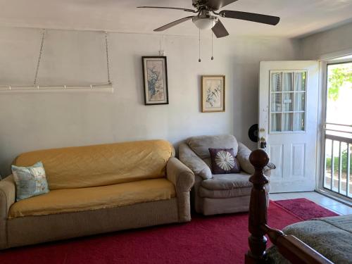 a living room with a couch and a chair at Va beach zen studio C in Virginia Beach