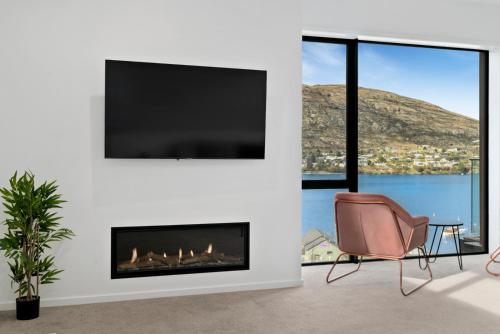 A television and/or entertainment center at Lakeside Bliss - Queenstown Holiday Home