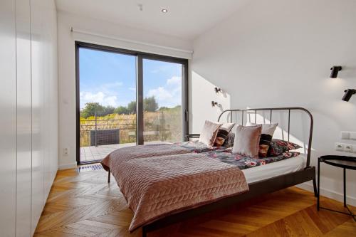 a bedroom with a bed and a large window at villa relax with swimming pool and mountain view in Buków
