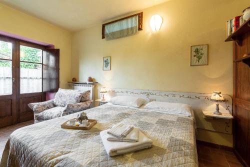 a bedroom with a large bed with towels on it at Ulivo in Radda in Chianti