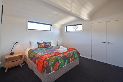 a bedroom with a king sized bed and a closet at Cass Crib - Lake Tekapo in Lake Tekapo
