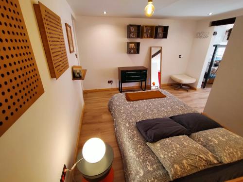 a bedroom with a bed and a piano in a room at Loft Montaña Central in Aller