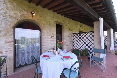 a table with a white table cloth on a patio at Fieno in SantʼAppiano