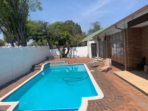 a large swimming pool in a backyard at Gold Reef Hideout in Johannesburg