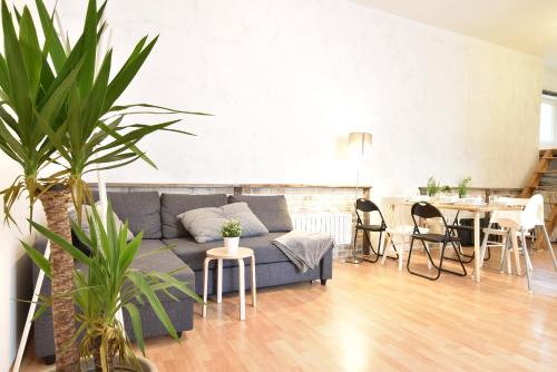 a living room with a couch and a table at Big place in city center with parking in Innsbruck