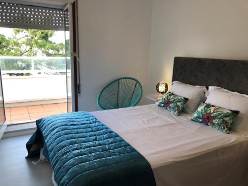 ein Schlafzimmer mit einem großen Bett und einem Balkon in der Unterkunft Beach House Cabedelo in Viana do Castelo