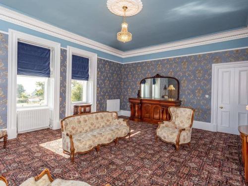 a living room with a couch and two chairs at North Bank House in Lybster