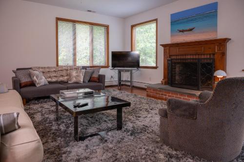 a living room with a couch and a fireplace at Summer and Fall in Sheffield with Monthly Special Pricing Available in Sheffield
