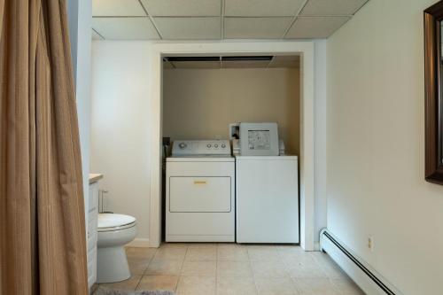 a bathroom with a washer and dryer and a toilet at Summer and Fall in Sheffield with Monthly Special Pricing Available in Sheffield