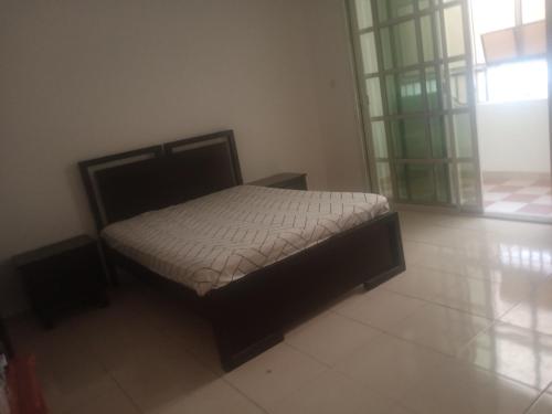 a small bed in a room with at Furnished hone stay villa with attached bathroom with balcony in Al 'Ayn