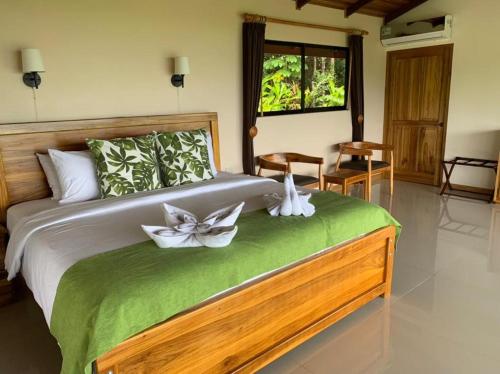 a bedroom with a large bed with flowers on it at Drake Bay Greenleaf in Drake