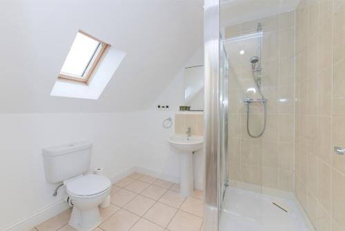 a bathroom with a toilet and a shower and a sink at Stunning Garden House with Free WIFI and Parking in Bingham