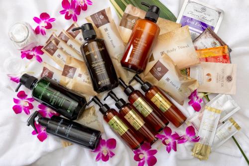 a group of products on a bed with flowers at HOTEL ARTIA DINOSAUR GIFU -Adult Only in Rokujō