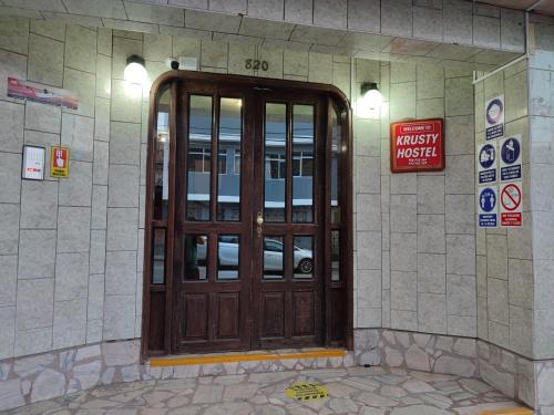 a wooden door on the side of a building at Krusty Hostel B&B in Huaraz