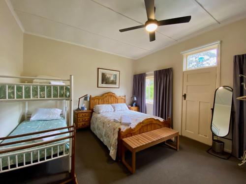 a bedroom with two beds and a ceiling fan at Mirradong Cottage in Berambing