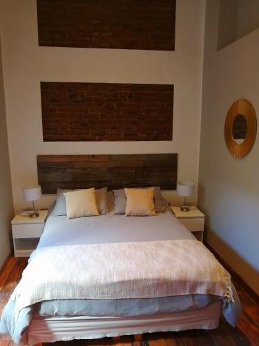 a bedroom with a large bed with two night stands at BO Hotel & Terraza in Valparaíso