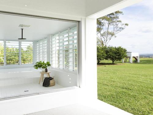 a window with a view of a green field at Amileka - luxury 25 acre estate with pool in Federal