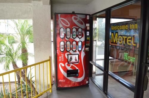 a vending machine with a bunch of remote controls on it at Welcome Inn Corona in Corona
