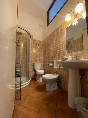 a bathroom with two toilets and a sink and a shower at Villa Sara in Taormina