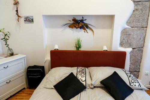 a bedroom with a bed with a red headboard at Penzion Willa in Jihlava