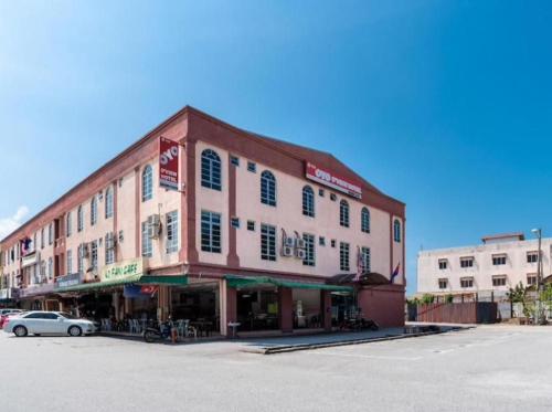 a large building with a car parked in front of it at HOTEL D VIEW MERSING in Mersing