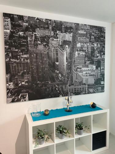 a living room with a picture of a city at Kemi city ll, near snowcastle, premium 3 rooms, kitchen , glazed balcony FREE PARKING in Kemi