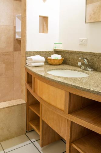 a bathroom with a sink and a shower at Holiday Surf Hotel (with full kitchen) in Honolulu