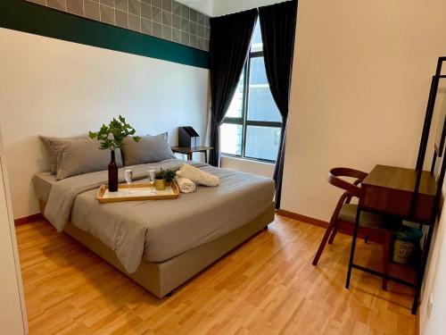 a bedroom with a bed with a tray with flowers on it at Kuantan Imperium by Glex in Kuantan