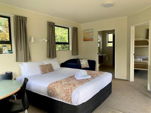 a bedroom with a bed with a hat on it at Omarama TOP10 Holiday Park in Omarama