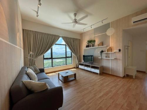 a living room with a couch and a large window at Kuantan Imperium by Glex in Kuantan