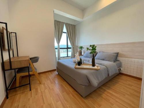 a bedroom with a bed with a desk and a window at Kuantan Imperium by Glex in Kuantan