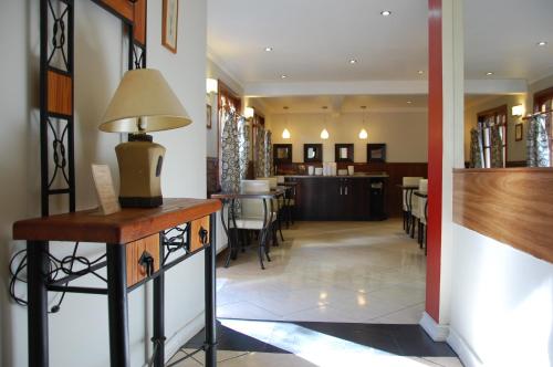 a kitchen with a stove, sink, and cabinets at Hotel Plaza Concepción in Concepción