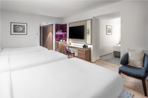 a hotel room with a bed and a desk at Makarem Ajyad Makkah Hotel in Makkah