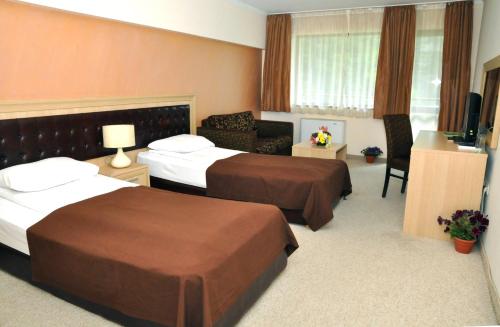 Postel nebo postele na pokoji v ubytování Olymp Hotel